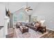 Bright living room with high ceilings, large windows, a fireplace, and hardwood floors at 116 Ivy Hollow Ln, Mooresville, NC 28117