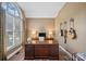 Office space featuring a large window, hardwood flooring, and ample desk space, ideal for productivity at 116 Ivy Hollow Ln, Mooresville, NC 28117