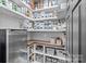 Walk-in pantry with shelving, countertop and bins for optimal organization and storage at 116 Ivy Hollow Ln, Mooresville, NC 28117