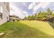 Expansive backyard, partially fenced, featuring a patio area under a gazebo, bordered by mature trees at 1178 Arges River Dr, Fort Mill, SC 29715