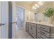 Neutral bathroom featuring a gray vanity and light-filled space with view into separate toilet/shower room at 1178 Arges River Dr, Fort Mill, SC 29715