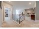 Well-lit hallway with carpeted floors and views of the living spaces at 1178 Arges River Dr, Fort Mill, SC 29715