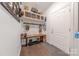 Well-organized mudroom with bench, hooks, and storage shelves offers a convenient entry point with rustic charm at 1178 Arges River Dr, Fort Mill, SC 29715