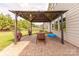 Cozy backyard patio featuring a shaded gazebo with a table and chairs, creating an ideal space for outdoor dining at 1178 Arges River Dr, Fort Mill, SC 29715