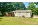 Charming single-story home featuring a covered porch and a well-maintained lawn surrounded by lush trees at 121 C & K Dr # 60, Taylorsville, NC 28681