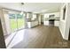 Modern kitchen with white cabinets, updated appliances, and vinyl flooring with natural light from a sliding glass door at 121 C & K Dr # 60, Taylorsville, NC 28681