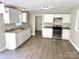 Bright kitchen with white cabinets, modern appliances, granite countertops, and stylish flooring at 121 C & K Dr # 60, Taylorsville, NC 28681
