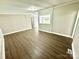 Spacious living room with updated vinyl flooring and neutral walls, perfect for relaxing or entertaining guests at 121 C & K Dr # 60, Taylorsville, NC 28681