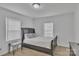 Comfortable bedroom features neutral paint, laminate flooring, and bright natural light from a window at 123 E Farmview St, Gastonia, NC 28054