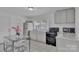 Inviting eat-in kitchen with sleek appliances, white cabinetry, granite countertops, and tile flooring at 123 E Farmview St, Gastonia, NC 28054