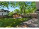 Well-maintained backyard with lush grass, wooden fencing, and a covered area at 1500 Pecan Ave, Charlotte, NC 28205