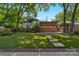 Spacious backyard with lush lawn, stone pathway, wooden fence, and covered parking area at 1500 Pecan Ave, Charlotte, NC 28205