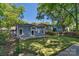 Landscaped backyard with lawn and pathway to a blue house with a wooden fence surrounding the property at 1500 Pecan Ave, Charlotte, NC 28205