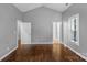 Bright bedroom features hardwood floors, gray walls, and a window at 1500 Pecan Ave, Charlotte, NC 28205