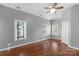 Spacious bedroom features hardwood floors, three windows, and a ceiling fan at 1500 Pecan Ave, Charlotte, NC 28205
