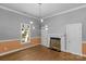 Dining room with hardwood floors, fireplace, and modern light fixture at 1500 Pecan Ave, Charlotte, NC 28205