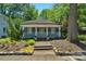Inviting single-story home with a covered front porch and meticulously maintained landscaping at 1500 Pecan Ave, Charlotte, NC 28205