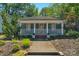 Charming single-story home with a covered porch, landscaped yard, and blue siding at 1500 Pecan Ave, Charlotte, NC 28205
