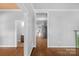 Bright hallway with hardwood floors and neutral walls leading to other rooms at 1500 Pecan Ave, Charlotte, NC 28205