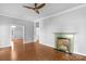 Bright living room features hardwood floors, fireplace, and a modern ceiling fan at 1500 Pecan Ave, Charlotte, NC 28205