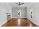 Spacious living room with hardwood floors, two windows, and decorative fireplace at 1500 Pecan Ave, Charlotte, NC 28205