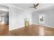 Bright living room featuring hardwood floors, a ceiling fan, and decorative fireplace at 1500 Pecan Ave, Charlotte, NC 28205
