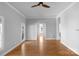 Open-concept living room featuring hardwood floors, a ceiling fan, and ample natural light at 1500 Pecan Ave, Charlotte, NC 28205