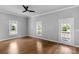 Bright living room with hardwood floors, three windows, and a ceiling fan at 1500 Pecan Ave, Charlotte, NC 28205