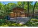 Covered parking area with wooden beams and a concrete pad, surrounded by a wooden privacy fence at 1500 Pecan Ave, Charlotte, NC 28205