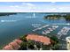 Aerial view of lake condo complex with boat dock and marina, showcasing its prime waterfront location at 17931 Kings Point Dr # E, Cornelius, NC 28031