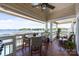 Covered porch with furniture and water views, offering a perfect spot to relax and enjoy the scenery at 17931 Kings Point Dr # E, Cornelius, NC 28031