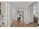 Bright hallway with wooden floors, white wainscoting, and views into other living spaces at 17931 Kings Point Dr # E, Cornelius, NC 28031