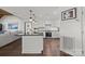 Open kitchen with granite countertops, stainless appliances, and hardwood flooring at 17931 Kings Point Dr # E, Cornelius, NC 28031