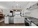 Gourmet kitchen with stainless steel appliances, breakfast bar, and bright lighting at 17931 Kings Point Dr # E, Cornelius, NC 28031