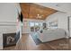 Spacious living room features fireplace, wood ceilings, and sliding door access to outside at 17931 Kings Point Dr # E, Cornelius, NC 28031