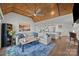 Comfortable living room with wood ceiling, fireplace, and open floor plan at 17931 Kings Point Dr # E, Cornelius, NC 28031