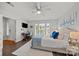 Bright main bedroom with a ceiling fan, a desk, and a bed with scenic views outside the window at 17931 Kings Point Dr # E, Cornelius, NC 28031