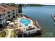 Aerial view of the waterfront pool and deck area with tables and lounge chairs at 17931 Kings Point Dr # E, Cornelius, NC 28031