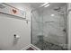 Beautiful bathroom featuring a spacious shower with marble tiling and glass enclosure at 17931 Kings Point Dr # E, Cornelius, NC 28031