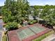 Aerial view of the on-site tennis court, surrounded by lush greenery and mature trees at 17931 Kings Point Dr # E, Cornelius, NC 28031