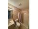Compact bathroom with a shower-tub combination, vanity, and floral wallpaper, maximizing space at 200 Breslin St, Wadesboro, NC 28170