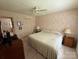 Relaxing bedroom with floral wallpaper, soft lighting, and a comfortable bed, creating a peaceful retreat at 200 Breslin St, Wadesboro, NC 28170