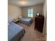 Comfortable bedroom with twin beds, natural light, and traditional decor, ideal for relaxation at 200 Breslin St, Wadesboro, NC 28170