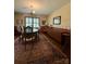 Traditional dining room featuring a wooden table, area rug, and wallpaper at 200 Breslin St, Wadesboro, NC 28170
