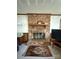 Close-up of brick fireplace with wooden mantel and decorative accents at 200 Breslin St, Wadesboro, NC 28170