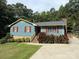 Charming one-story home featuring red shutters and manicured landscaping on a verdant, tree-lined lot at 200 Breslin St, Wadesboro, NC 28170