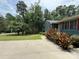Inviting one-story home with red shutters sits on a well-manicured lot in a tree-lined area at 200 Breslin St, Wadesboro, NC 28170