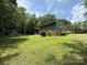 One-story home with large yard, a shed and play set sits on a well-manicured lot with mature trees at 200 Breslin St, Wadesboro, NC 28170