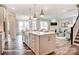 Open kitchen with stainless steel appliances, stone counters, pendant lights and view to the living area at 2015 Mantle Rdg # 194, Indian Trail, NC 28079