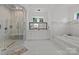 Elegant bathroom featuring a glass-enclosed shower, soaking tub, and double vanity, designed for ultimate relaxation at 2117 Middlebridge Ct, Fort Mill, SC 29715